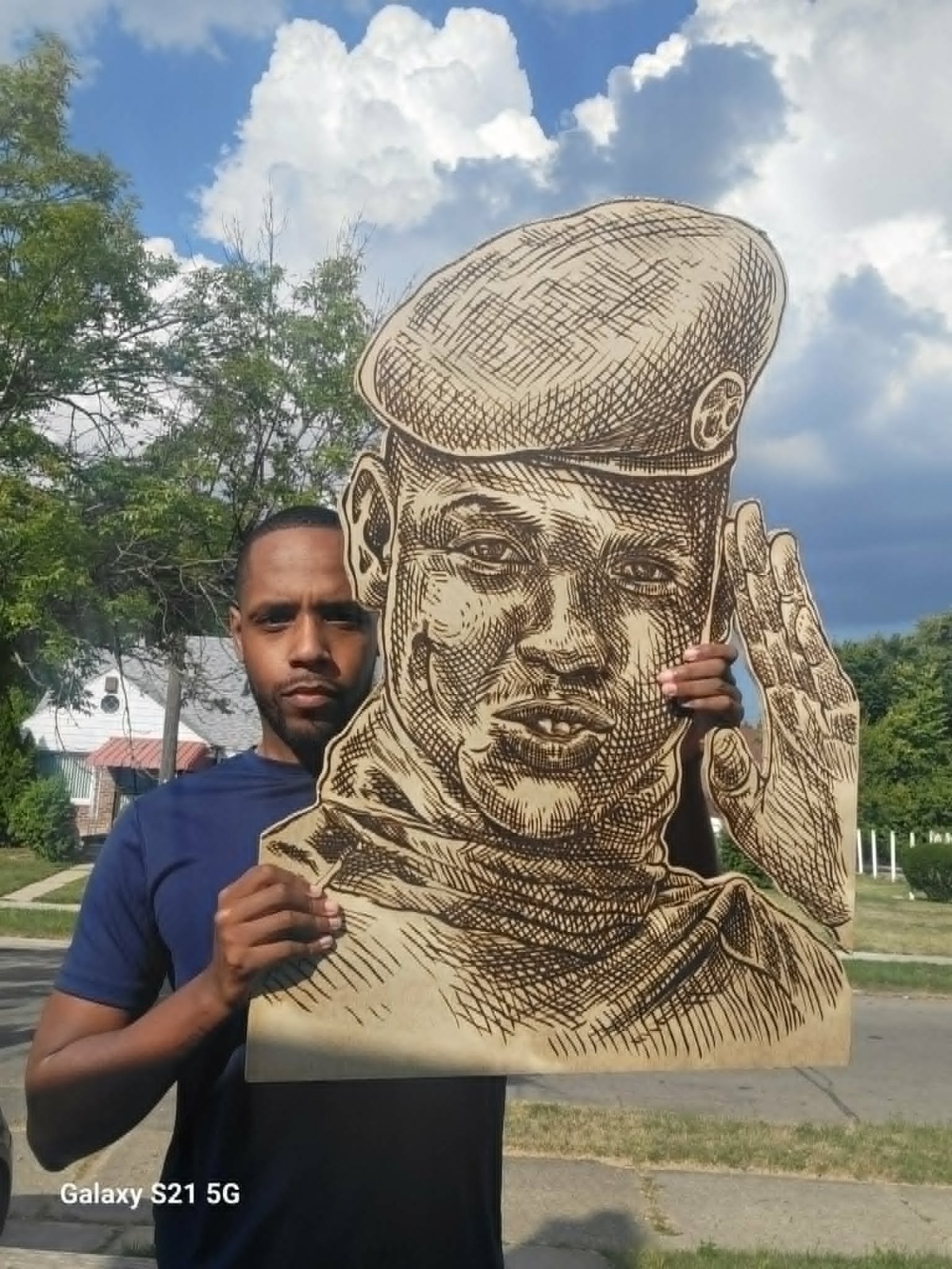 Large pyrography portrait held outdoors